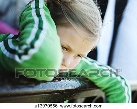 Stock Photograph - Girl leaning over banister. Fotosearch