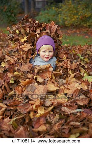 Picture - Girl playing in autumn leaves. Fotosearch