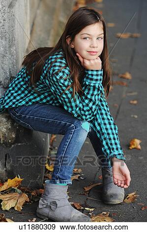Girl sitting on corner of urban street View Large Photo Image Stock Photo - Girl sitting on corner of urban street. Fotosearch