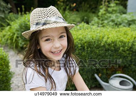 Stock Photo - Girl smiling in backyard. Fotosearch