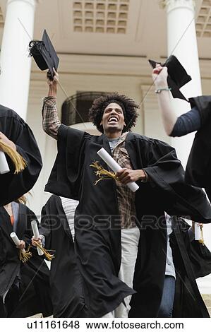 Graduates cheering on campus View Large Photo Image Stock Photo - Graduates cheering on campus. Fotosearch