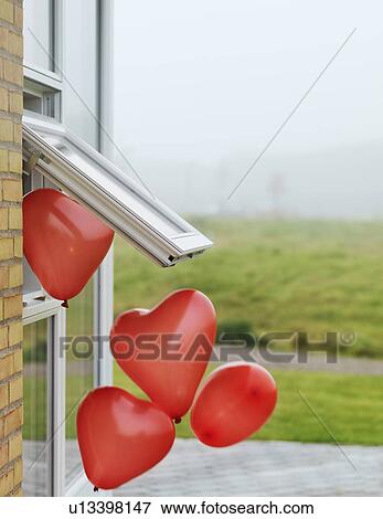 Heart-shaped balloons outside window View Large Photo Image Stock Photo - Heart-shaped balloons outside window. Fotosearch
