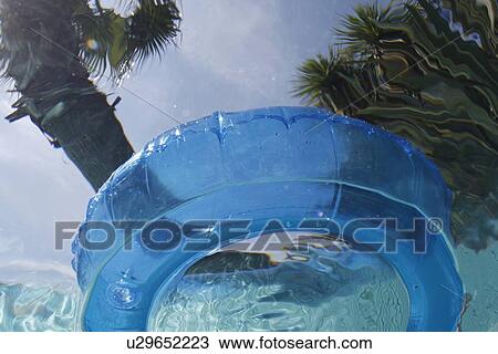 Stock Image - Inner tube viewed from underwater. Fotosearch