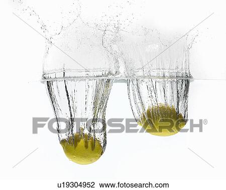 Lemons splashing in water View Large Photo Image Stock Image - Lemons splashing in water. Fotosearch