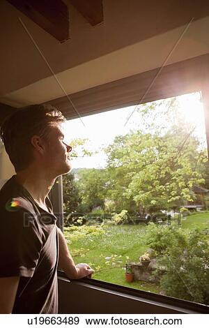 Man admiring landscape from window View Large Photo Image Stock Photo - Man admiring landscape from window. Fotosearch