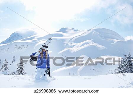 Man carrying snowboard in snow View Large Photo Image Stock Photograph - Man carrying snowboard in snow. Fotosearch