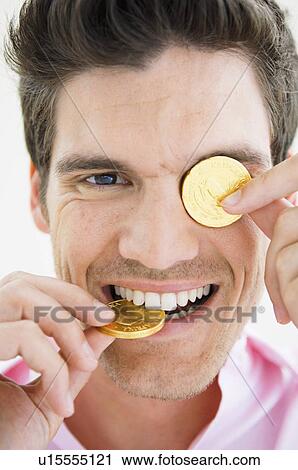 Man playing with gold coins View Large Photo Image Stock Image - Man playing with gold coins. Fotosearch
