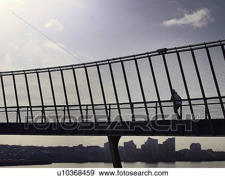 Stock Photo - Man running on skybridge. Fotosearch
