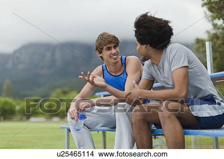 Picture - Men talking on bleachers in park. Fotosearch