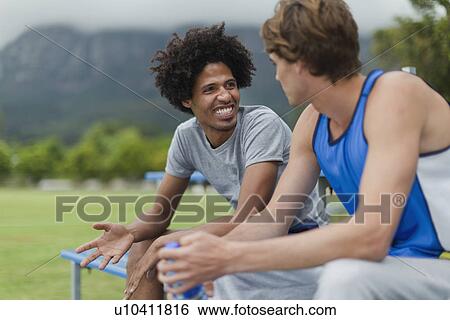 Men talking on bleachers in park View Large Photo Image Stock Photograph - Men talking on bleachers in park. Fotosearch