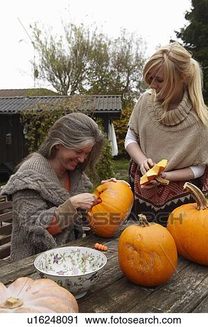 Mother and daughter carving pumpkins View Large Photo Image Stock Image - Mother and daughter carving pumpkins. Fotosearch