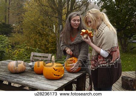 Mother and daughter carving pumpkins View Large Photo Image Stock Image - Mother and daughter carving pumpkins. Fotosearch