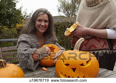 Mother and daughter carving pumpkins View Large Photo Image Stock Photo - Mother and daughter carving pumpkins. Fotosearch