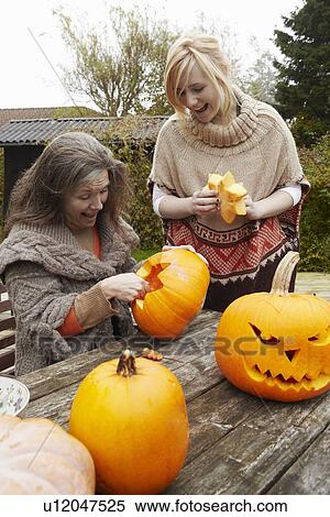 Mother and daughter carving pumpkins View Large Photo Image Stock Photography - Mother and daughter carving pumpkins. Fotosearch