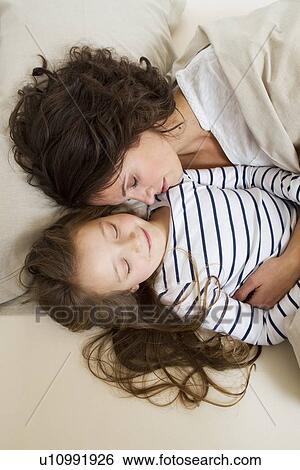 Mother and daughter relaxing in bed View Large Photo Image Stock Photograph - Mother and daughter relaxing in bed. Fotosearch