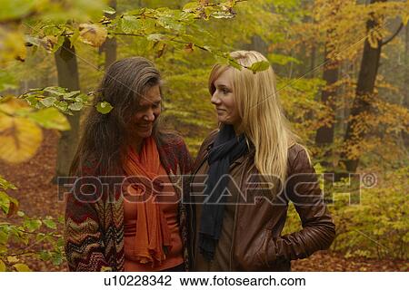 Mother and daughter talking in forest View Large Photo Image Stock Image - Mother and daughter talking in forest. Fotosearch