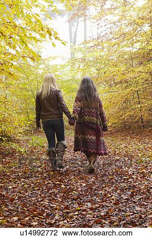 Mother and daughter walking in forest View Large Photo Image Stock Image - Mother and daughter walking in forest. Fotosearch