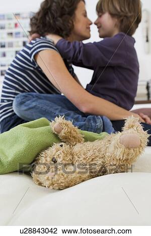Mother and son relaxing in living room View Large Photo Image Stock Image - Mother and son relaxing in living room. Fotosearch