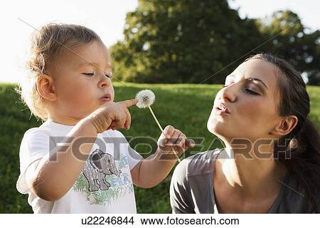 Mother and toddler playing in park View Large Photo Image Picture - Mother and toddler playing in park. Fotosearch