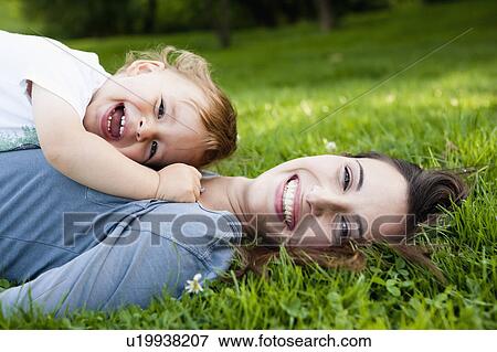 Stock Photo - Mother holding toddler in park. Fotosearch
