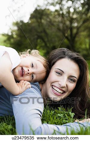 Mother playing with toddler in park View Large Photo Image Stock Photography - Mother playing with toddler in park. Fotosearch
