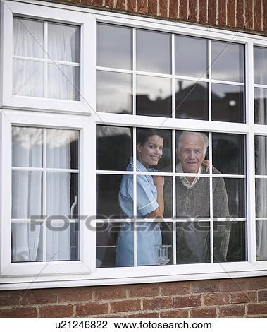 Nurse and older man at window View Large Photo Image Stock Image - Nurse and older man at window. Fotosearch