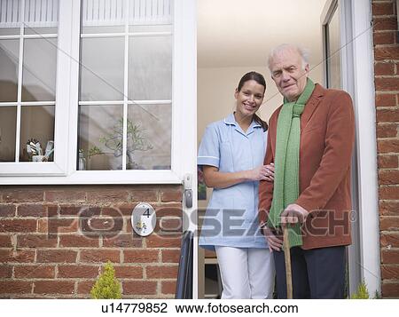Nurse and older man standing in doorway View Large Photo Image Stock Image - Nurse and older man standing in doorway. Fotosearch