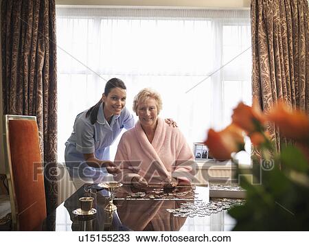Nurse and older woman with jigsaw puzzle View Large Photo Image Stock Image - Nurse and older woman with jigsaw puzzle. Fotosearch