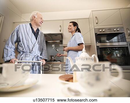 Nurse cooking for older man in kitchen View Large Photo Image Stock Photography - Nurse cooking for older man in kitchen. Fotosearch