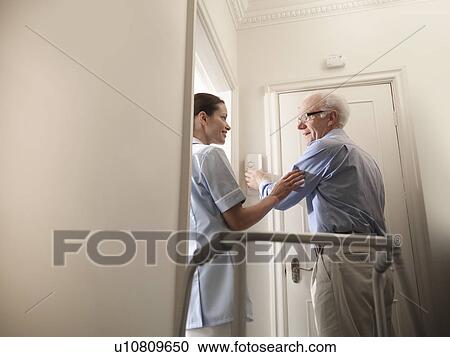 Nurse talking to older man in house View Large Photo Image Stock Image - Nurse talking to older man in house. Fotosearch