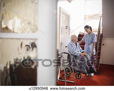 Nurse talking to older man in wheelchair View Large Photo Image Stock Photo - Nurse talking to older man in wheelchair. Fotosearch