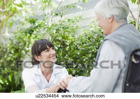 Nurse talking to older patient outdoors View Large Photo Image Picture - Nurse talking to older patient outdoors. Fotosearch