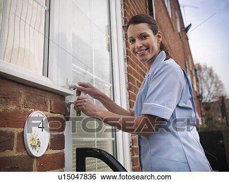 Nurse unlocking front door View Large Photo Image Stock Photograph - Nurse unlocking front door. Fotosearch