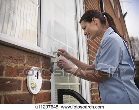 Nurse unlocking front door View Large Photo Image Stock Photography - Nurse unlocking front door. Fotosearch