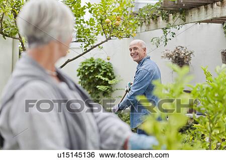 Older couple gardening in backyard View Large Photo Image Stock Photograph - Older couple gardening in backyard. Fotosearch