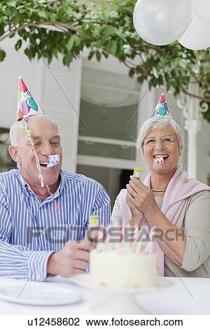 Older couple laughing at birthday party View Large Photo Image Stock Image - Older couple laughing at birthday party. Fotosearch