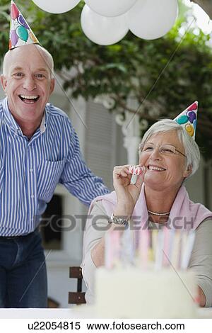 Older couple laughing at birthday party View Large Photo Image Stock Photography - Older couple laughing at birthday party. Fotosearch