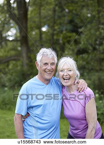 Older couple laughing together in park View Large Photo Image Stock Image - Older couple laughing together in park. Fotosearch
