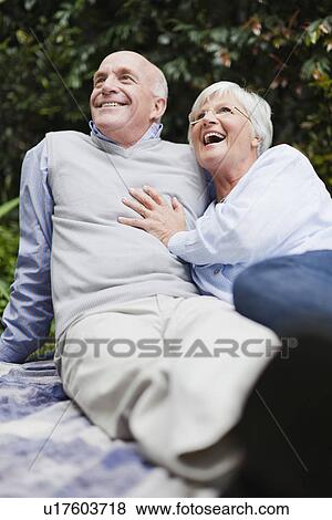 Older couple relaxing together outdoors View Large Photo Image Stock Photo - Older couple relaxing together outdoors. Fotosearch