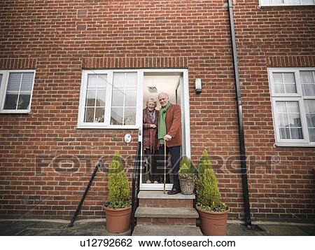 Older couple standing in doorway View Large Photo Image Stock Image - Older couple standing in doorway. Fotosearch