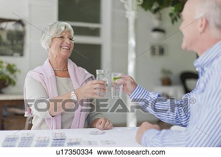 Picture - Older couple toasting each other. Fotosearch