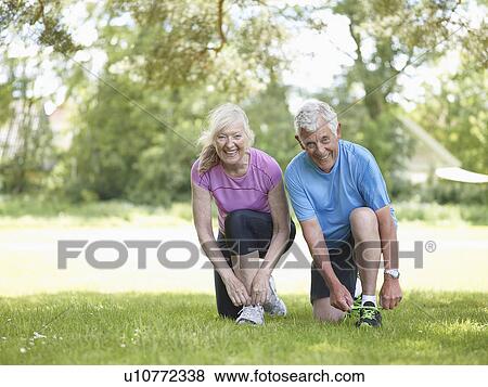 Stock Photo - Older couple tying their shoelaces. Fotosearch
