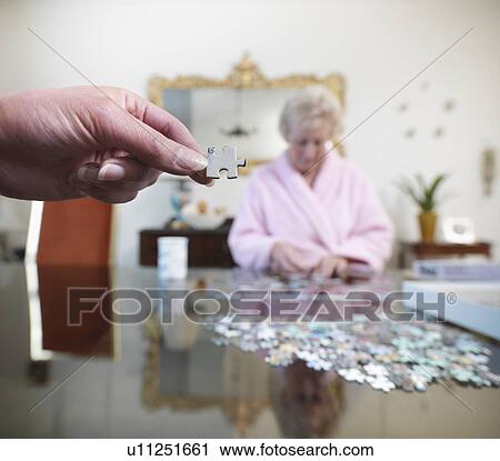 Older couple working on jigsaw puzzle View Large Photo Image Stock Image - Older couple working on jigsaw puzzle. Fotosearch