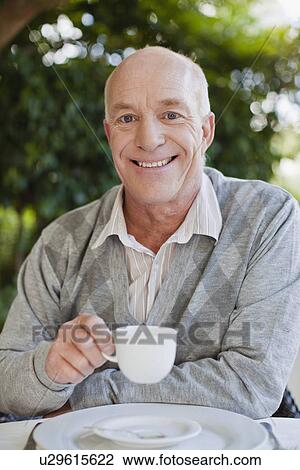 Older man having cup of coffee View Large Photo Image Stock Image - Older man having cup of coffee. Fotosearch