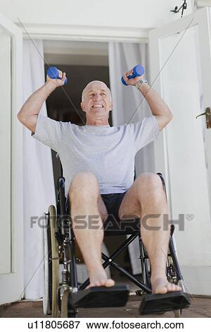 Older man in wheelchair lifting weights View Large Photo Image Stock Photo - Older man in wheelchair lifting weights. Fotosearch