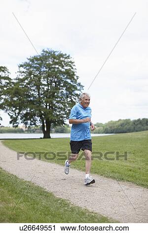 Older man jogging on dirt path View Large Photo Image Stock Image - Older man jogging on dirt path. Fotosearch