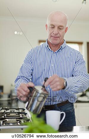 Picture - Older man pouring cup of coffee. Fotosearch