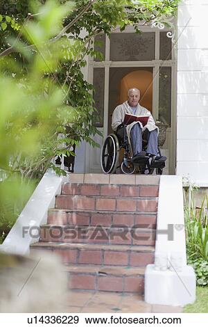 Older man reading in wheelchair View Large Photo Image Stock Photo - Older man reading in wheelchair. Fotosearch