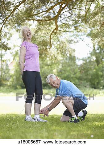 Stock Photo - Older man tying wifes shoelaces. Fotosearch
