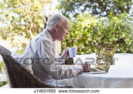Older man using laptop outdoors View Large Photo Image Stock Image - Older man using laptop outdoors. Fotosearch